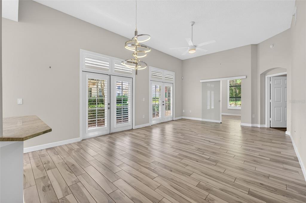 701 Westpark Way, Unit 101 Celebration, FL 34747 - Photo 12 of 69 a view of an empty room with wooden floor and a window