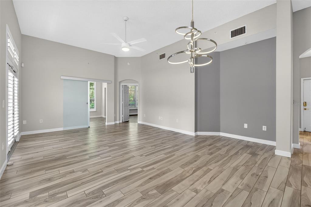 701 Westpark Way, Unit 101 Celebration, FL 34747 - Photo 13 of 69 a view of an empty room with wooden floor and a ceiling fan