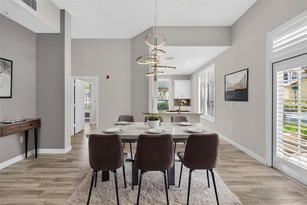 701 Westpark Way, Unit 101 Celebration, FL 34747 - Photo 17 of 69 a view of a a dining room with furniture window and wooden floor