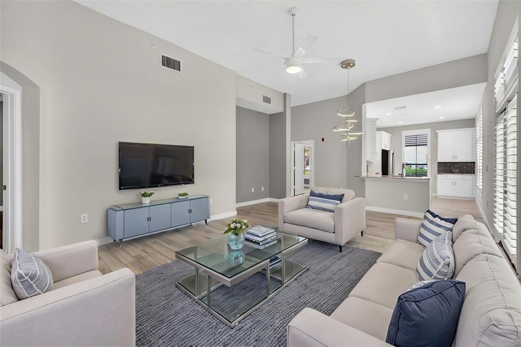 701 Westpark Way, Unit 101 Celebration, FL 34747 - Photo 19 of 69 a living room with furniture and a flat screen tv