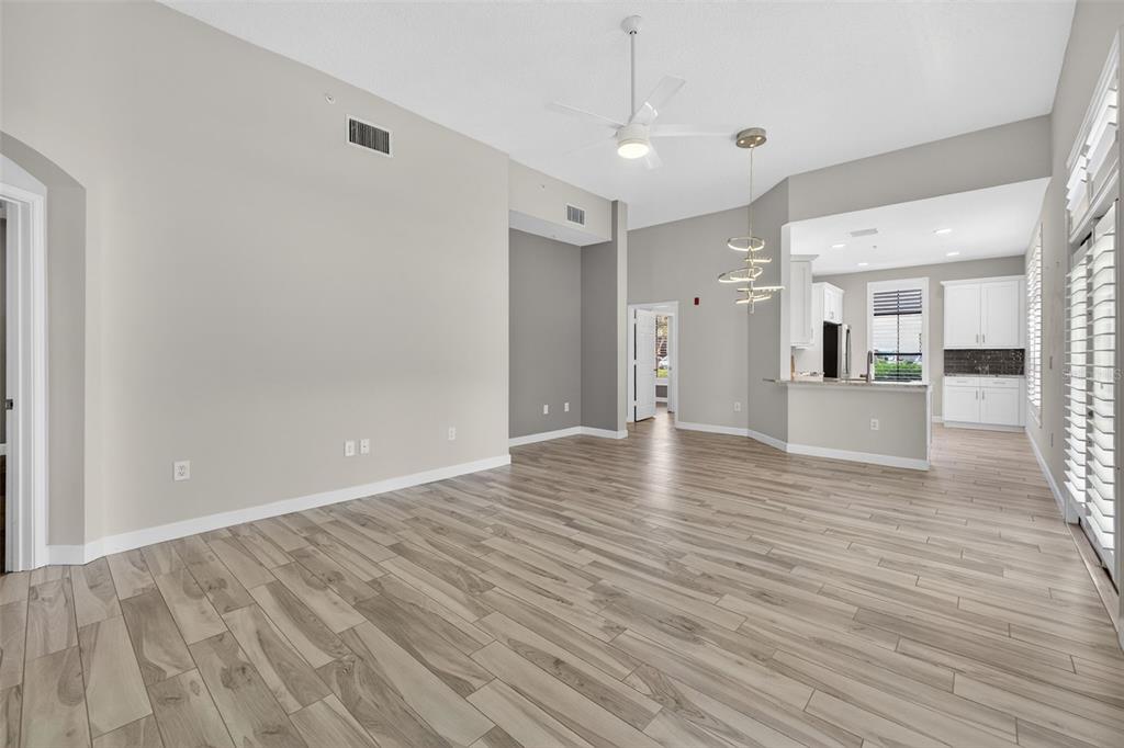 701 Westpark Way, Unit 101 Celebration, FL 34747 - Photo 20 of 69 an empty room with wooden floor and windows
