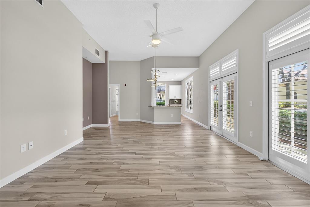 701 Westpark Way, Unit 101 Celebration, FL 34747 - Photo 22 of 69 a view of an empty room with wooden floor and a window