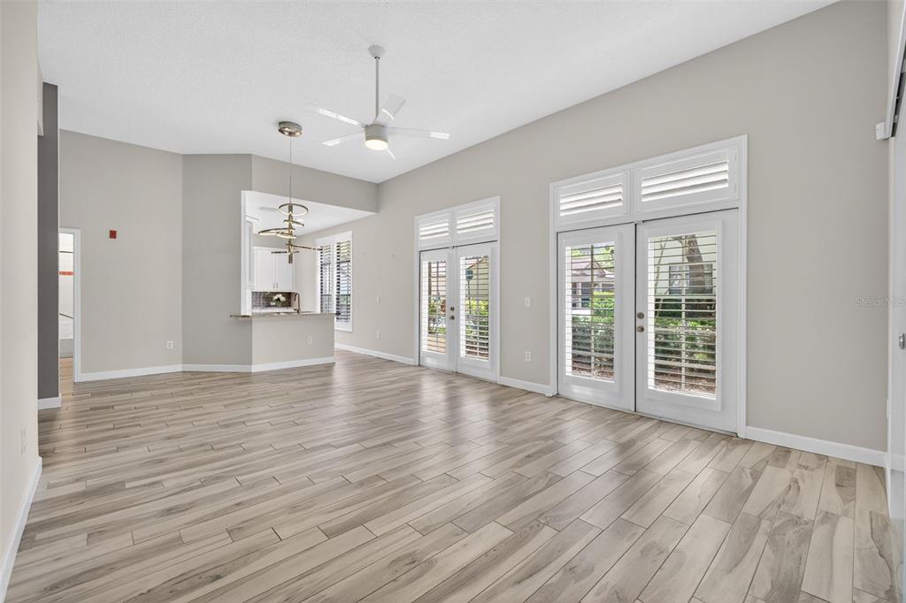 701 Westpark Way, Unit 101 Celebration, FL 34747 - Photo 23 of 69 a view of an empty room with wooden floor and a window