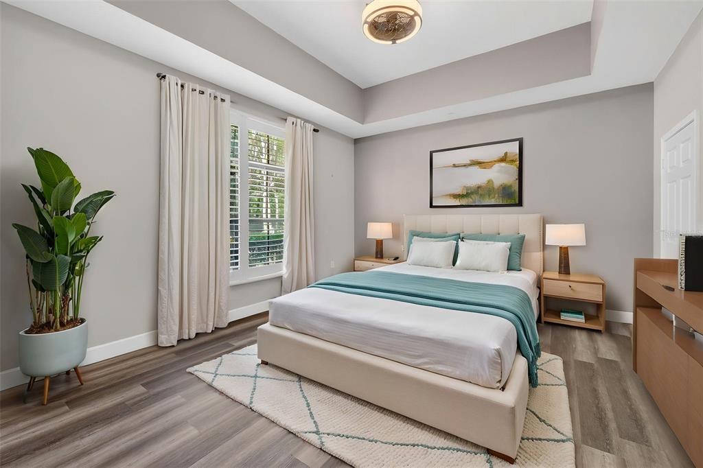 701 Westpark Way, Unit 101 Celebration, FL 34747 - Photo 24 of 69 a bedroom with a bed and a potted plant