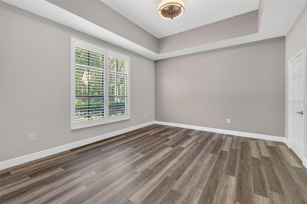 701 Westpark Way, Unit 101 Celebration, FL 34747 - Photo 25 of 69 a view of an empty room with wooden floor and a window