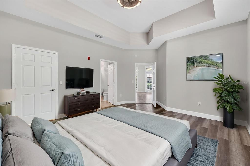 701 Westpark Way, Unit 101 Celebration, FL 34747 - Photo 26 of 69 a bedroom with a bed and a flat screen tv