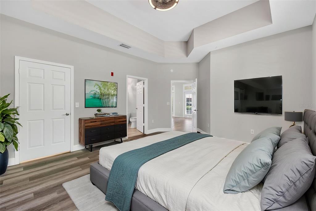 701 Westpark Way, Unit 101 Celebration, FL 34747 - Photo 27 of 69 a bedroom with a bed and a television