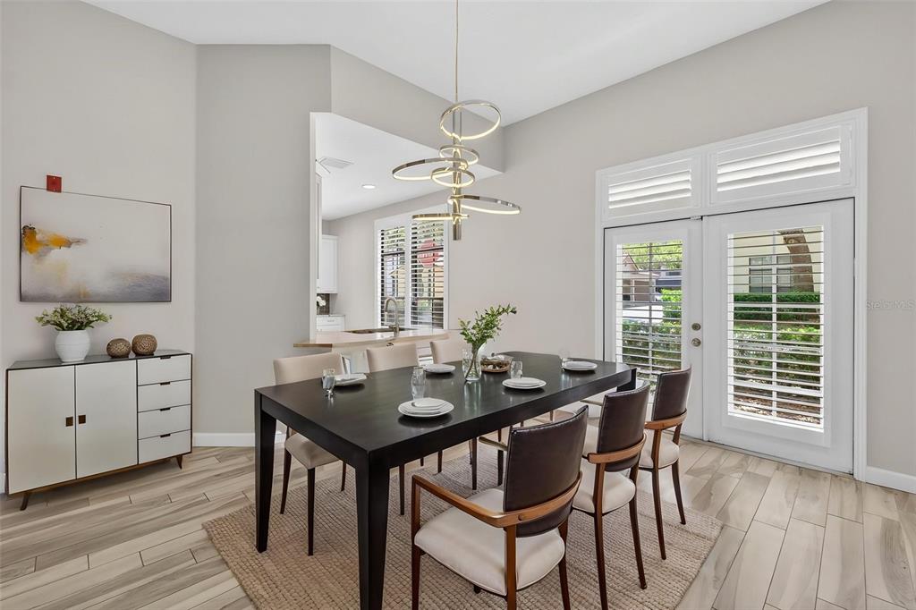 701 Westpark Way, Unit 101 Celebration, FL 34747 - Photo 3 of 69 a view of a dining room with furniture window and wooden floor