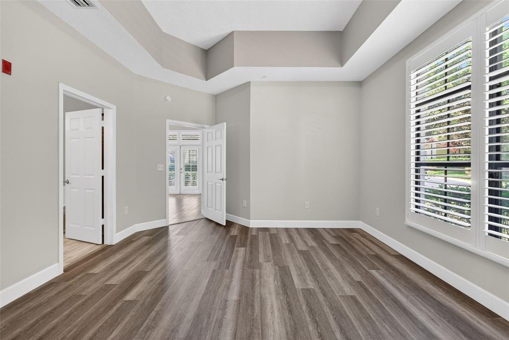 701 Westpark Way, Unit 101 Celebration, FL 34747 - Photo 32 of 69 a view of an empty room with wooden floor and a window