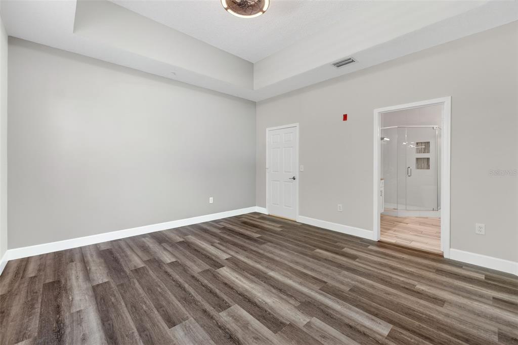 701 Westpark Way, Unit 101 Celebration, FL 34747 - Photo 33 of 69 a view of an empty room with wooden floor