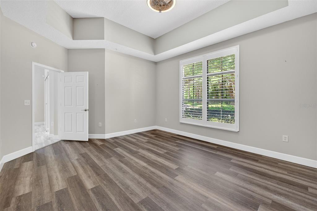 701 Westpark Way, Unit 101 Celebration, FL 34747 - Photo 34 of 69 a view of an empty room with wooden floor and a window