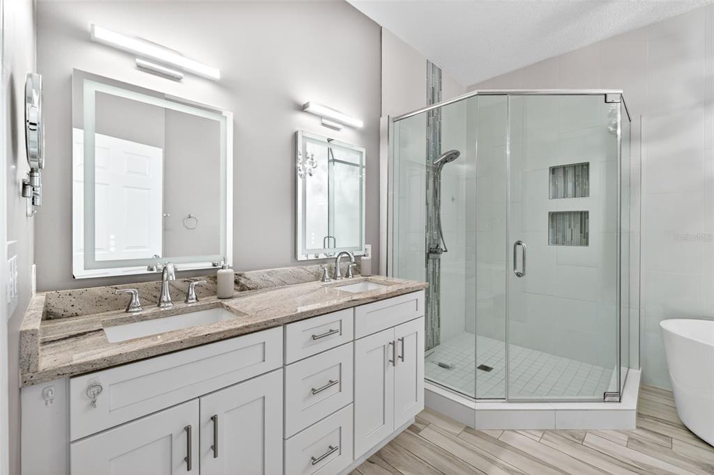 701 Westpark Way, Unit 101 Celebration, FL 34747 - Photo 35 of 69 a bathroom with a shower sink vanity granite and shower