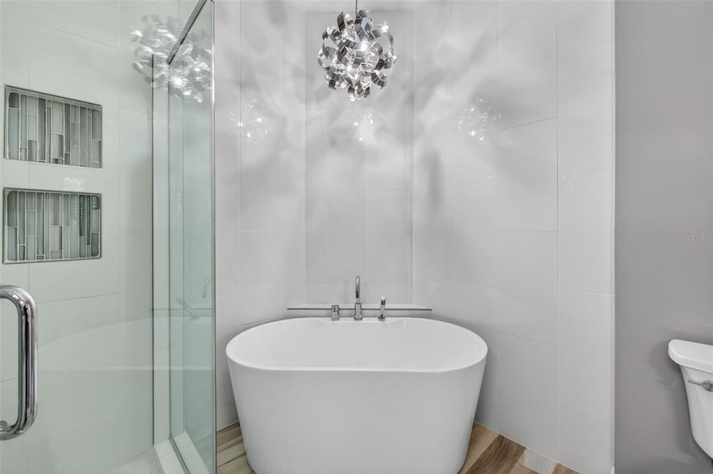 701 Westpark Way, Unit 101 Celebration, FL 34747 - Photo 38 of 69 a white bath tub sitting next to a white sink