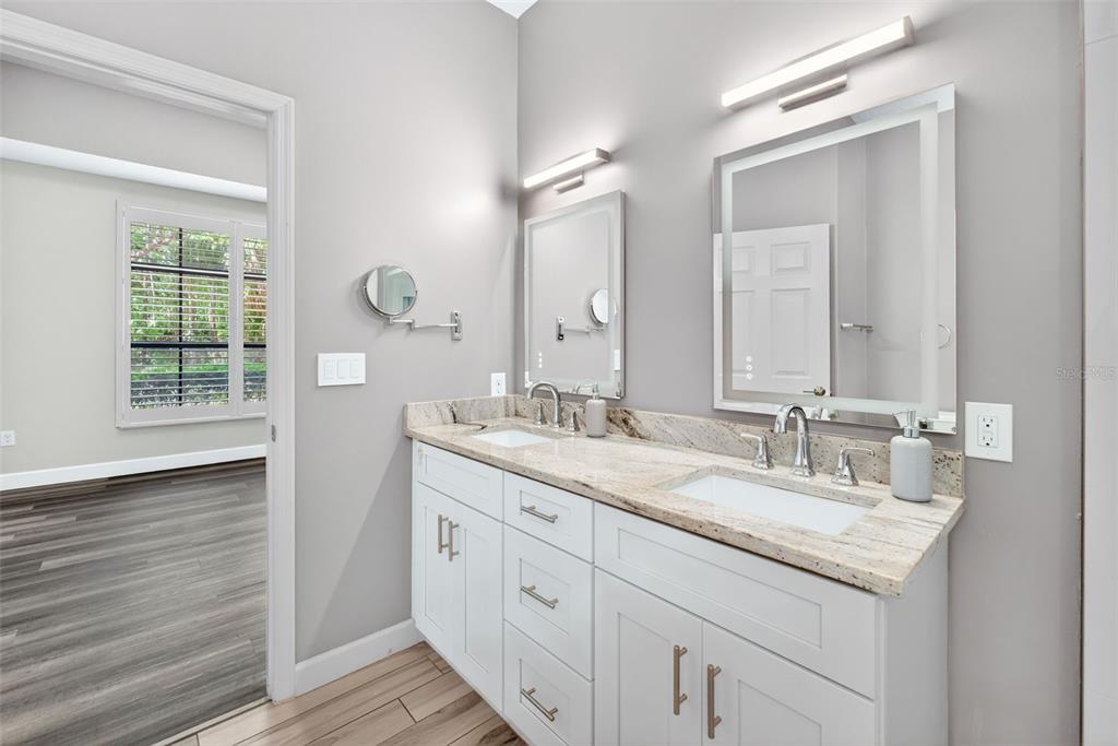 701 Westpark Way, Unit 101 Celebration, FL 34747 - Photo 40 of 69 a bathroom with a double vanity sink and a mirror