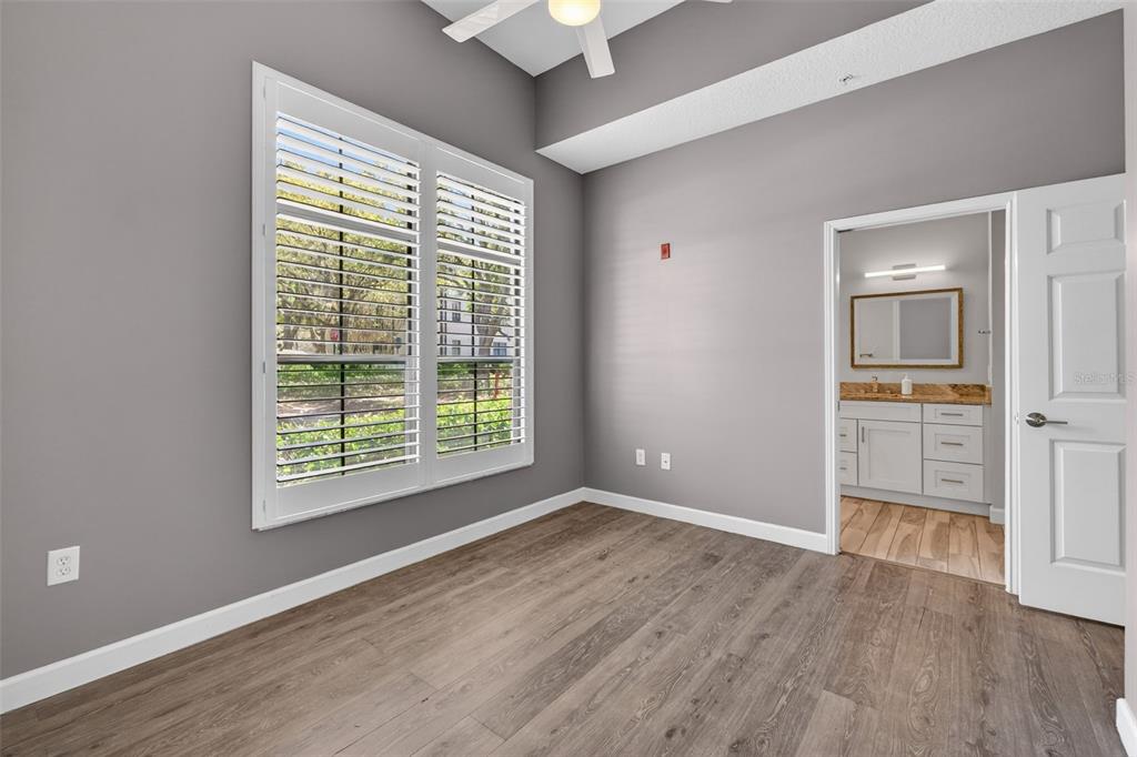 701 Westpark Way, Unit 101 Celebration, FL 34747 - Photo 43 of 69 a view of an empty room with a window and wooden floor