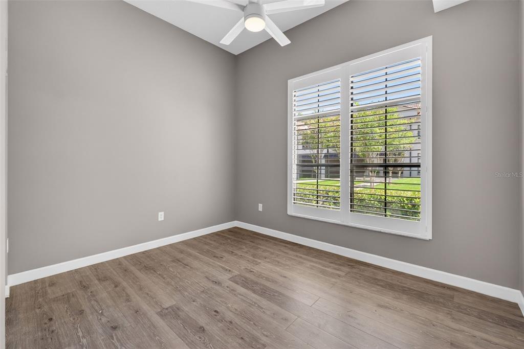 701 Westpark Way, Unit 101 Celebration, FL 34747 - Photo 45 of 69 a view of an empty room with wooden floor and a window