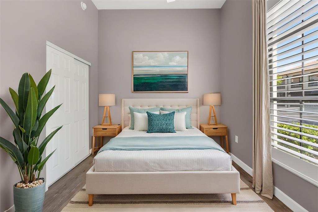 701 Westpark Way, Unit 101 Celebration, FL 34747 - Photo 46 of 69 a bedroom with a large bed and a potted plant