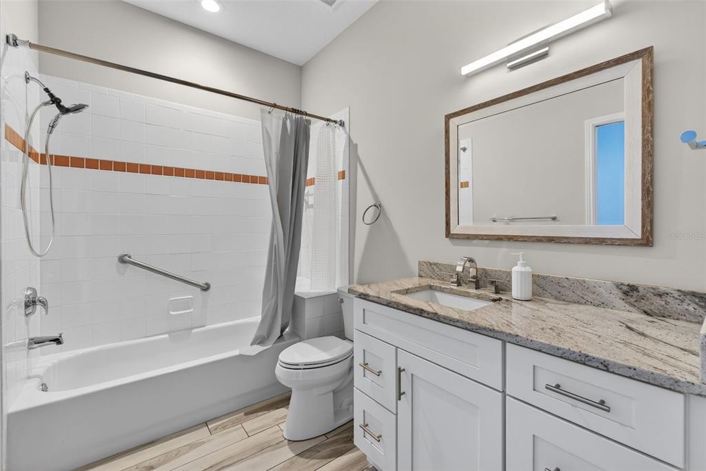 701 Westpark Way, Unit 101 Celebration, FL 34747 - Photo 49 of 69 a bathroom with a granite countertop sink mirror vanity and toilet