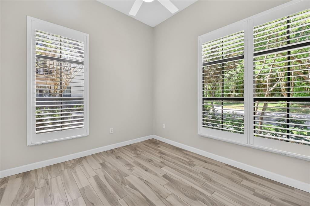 701 Westpark Way, Unit 101 Celebration, FL 34747 - Photo 52 of 69 a view of an empty room with wooden floor and a window