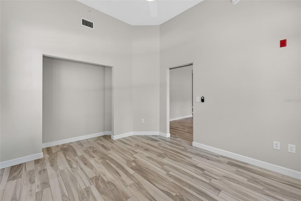 701 Westpark Way, Unit 101 Celebration, FL 34747 - Photo 54 of 69 a view of an empty room with wooden floor