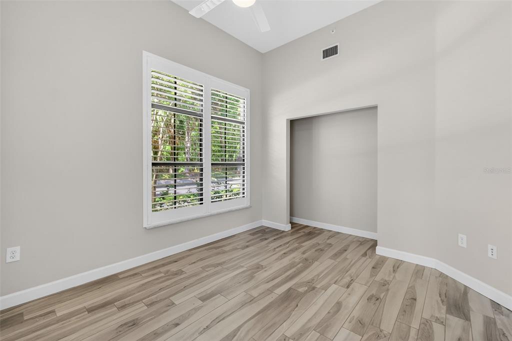 701 Westpark Way, Unit 101 Celebration, FL 34747 - Photo 55 of 69 a view of an empty room with wooden floor and a window