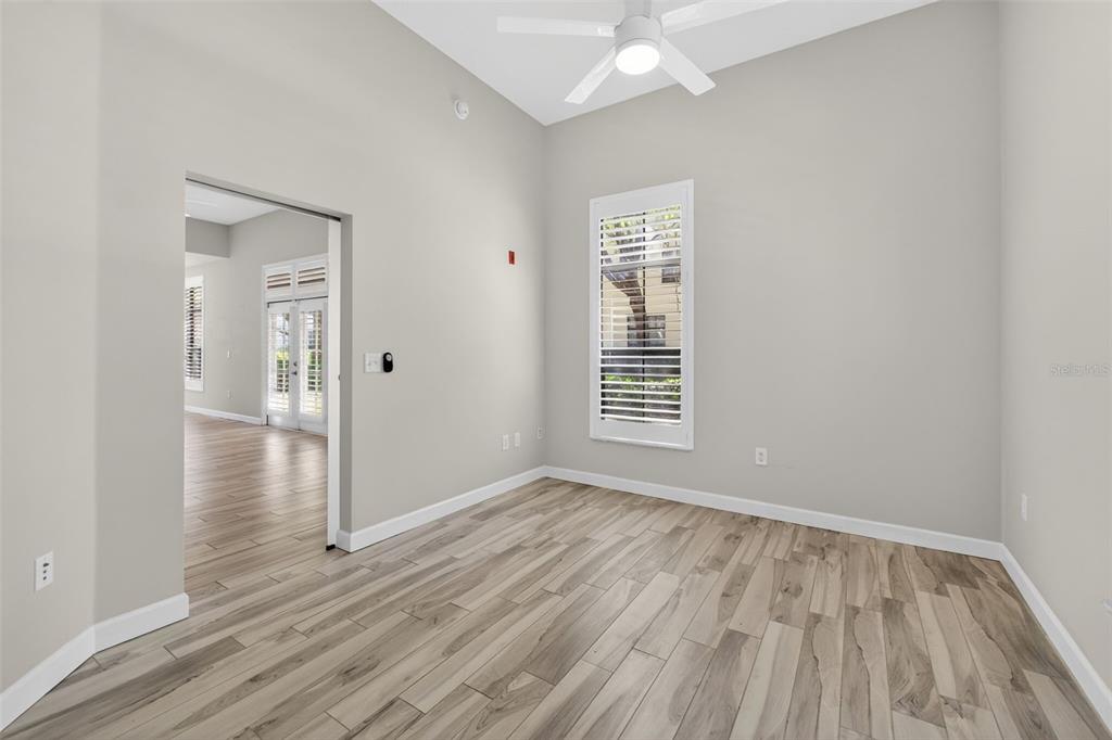 701 Westpark Way, Unit 101 Celebration, FL 34747 - Photo 56 of 69 an empty room with wooden floor closet and windows