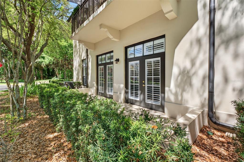 701 Westpark Way, Unit 101 Celebration, FL 34747 - Photo 60 of 69 a view of a house with a small yard and floor to ceiling window and wooden fence
