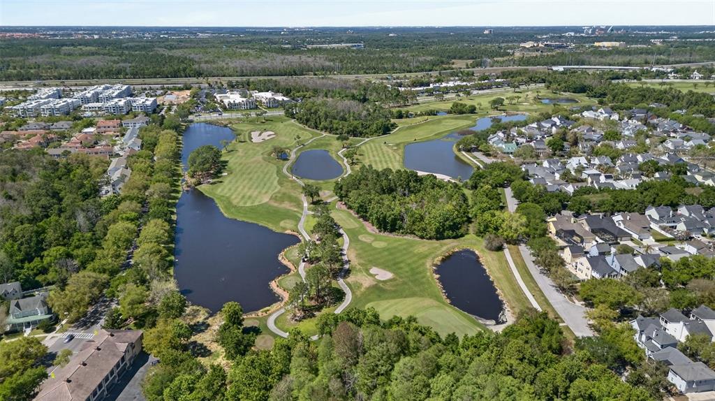 701 Westpark Way, Unit 101 Celebration, FL 34747 - Photo 66 of 69 an aerial view of residential houses with outdoor space and trees