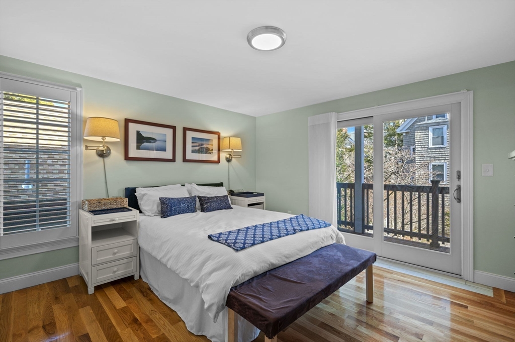 9 Hanover Court, Unit 1 Marblehead, MA 01945 - Photo 17 of 38 a bedroom with a bed and wooden floor
