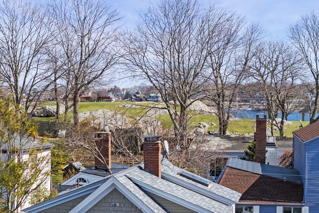 9 Hanover Court, Unit 1 Marblehead, MA 01945 - Photo 29 of 38 a view of a yard with wooden fence