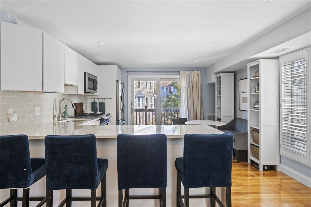 9 Hanover Court, Unit 1 Marblehead, MA 01945 - Photo 7 of 38 a dining room with furniture and a floor to ceiling window