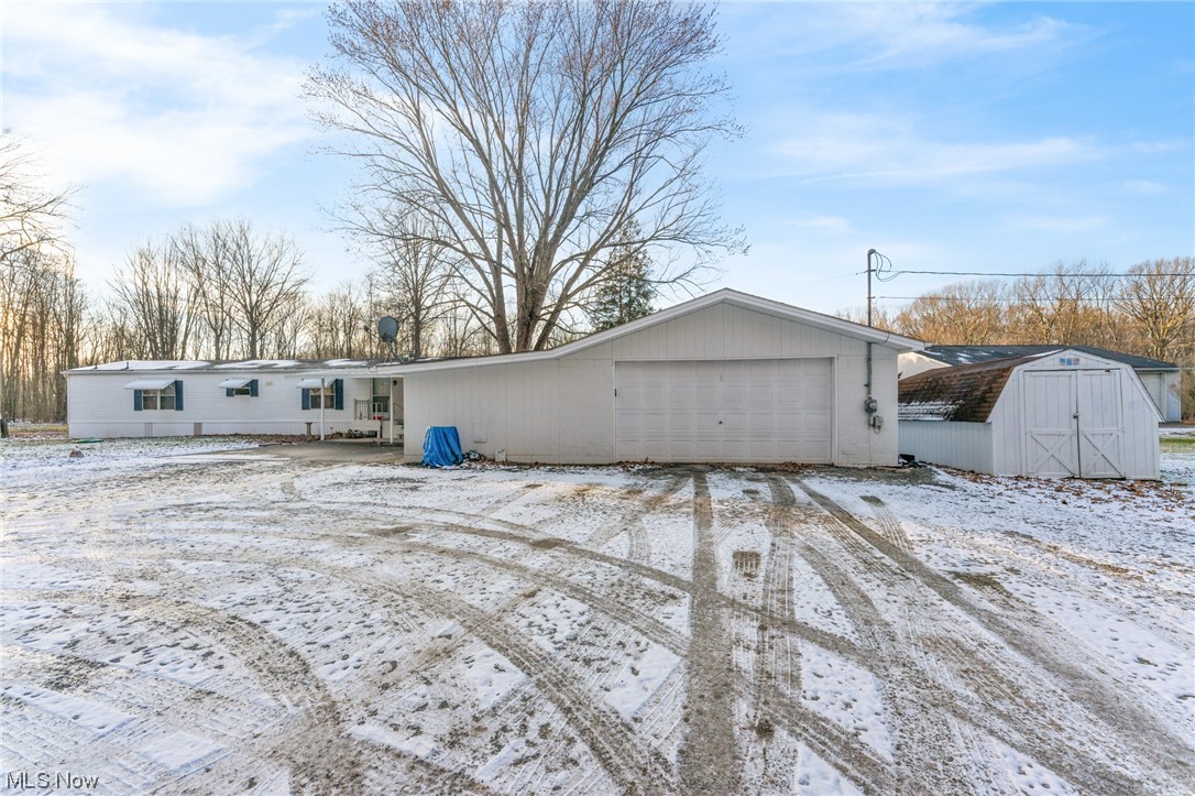 11579 Beard Road New Springfield, OH 44443 - Photo 21 of 22 Snow covered property with a storage shed