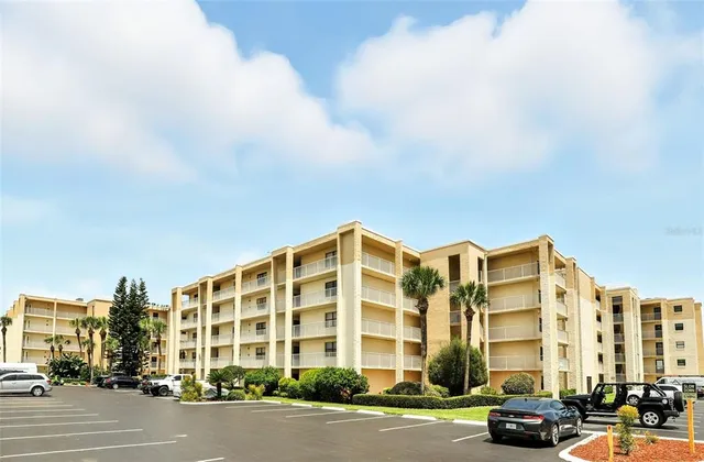 a kitchen with granite countertop a stove top oven and cabinets