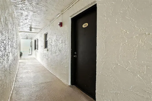 a kitchen with granite countertop white cabinets and stainless steel appliances