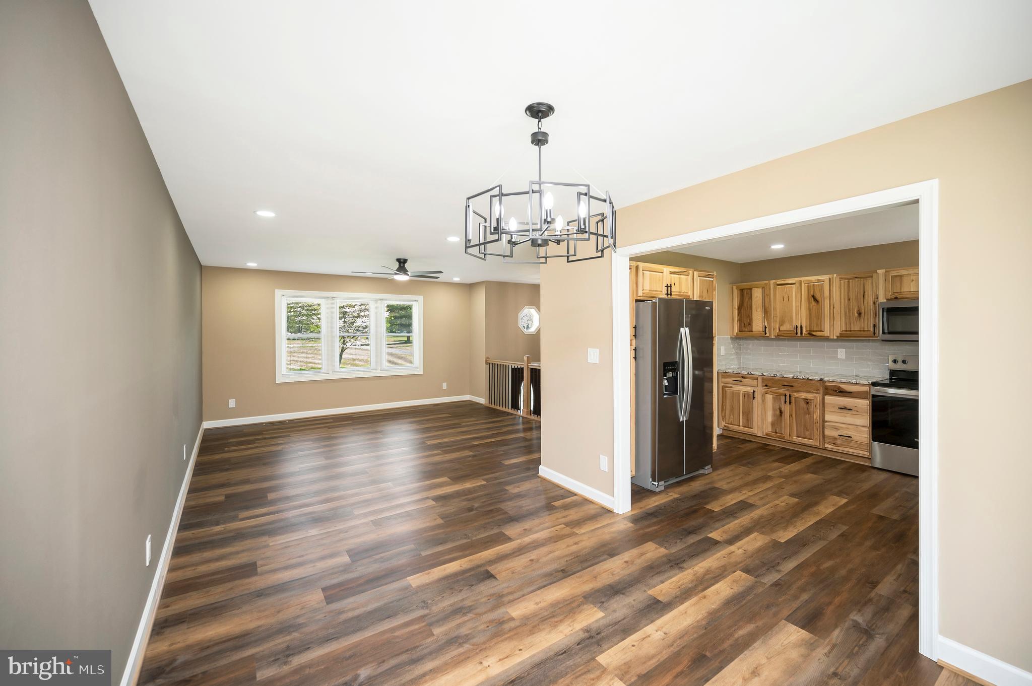13452 Post Oak Road Spotsylvania, VA 22551 - Photo 23 of 56 a view of a hallway with wooden floor and a kitchen