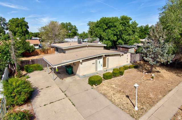 669 Colonial Avenue Layton, UT 84041 - Photo 38 of 51 Brick exterior with a covered carport, concrete driveway, and front yard landscaping