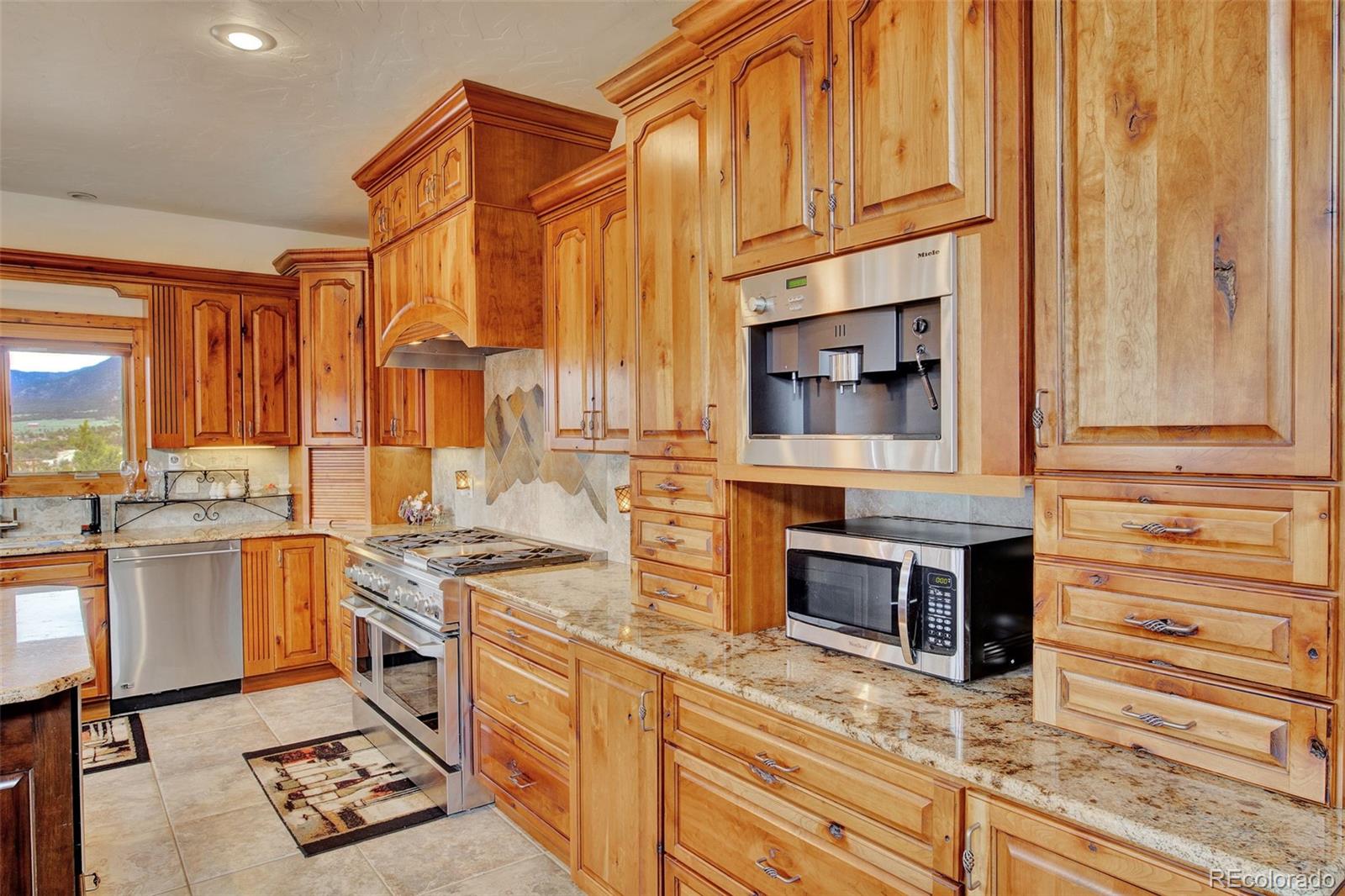 400 Copper Canyon Road Canon City, CO 81212 - Photo 15 of 50 a kitchen with stainless steel appliances granite countertop a stove and a sink
