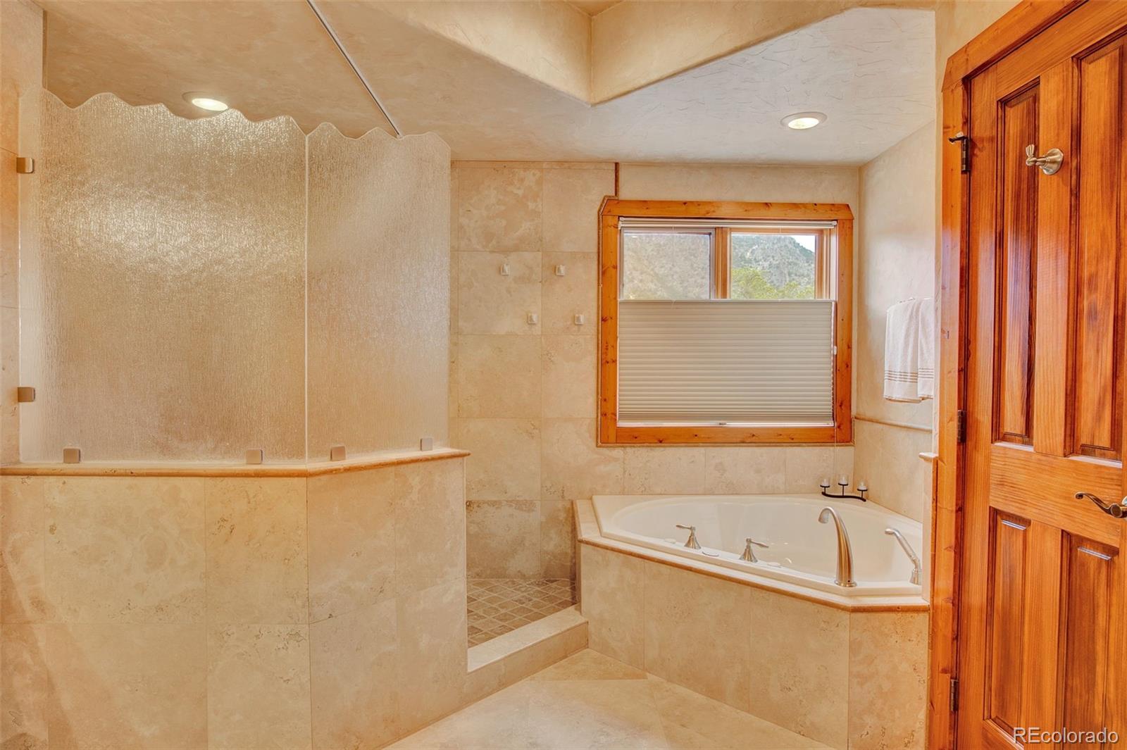400 Copper Canyon Road Canon City, CO 81212 - Photo 20 of 50 a bathroom with a granite countertop window and a bathtub