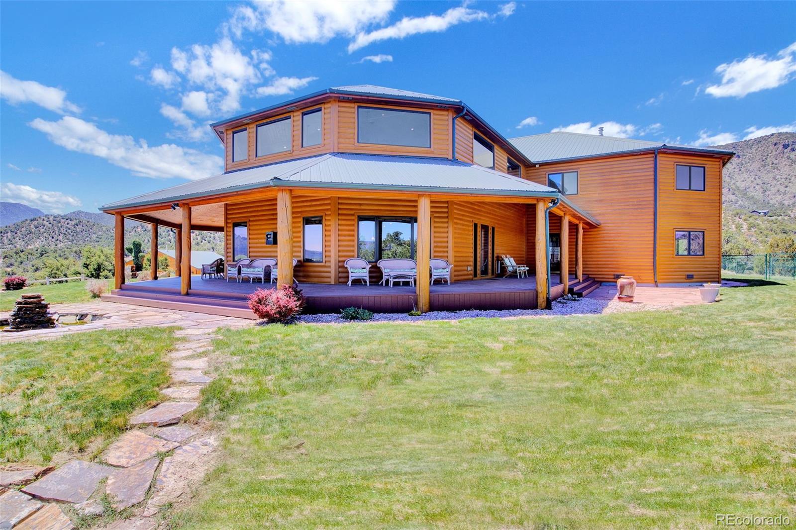 400 Copper Canyon Road Canon City, CO 81212 - Photo 3 of 50 a front view of a house with swimming pool