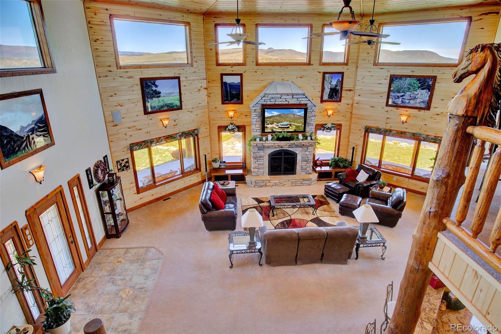 400 Copper Canyon Road Canon City, CO 81212 - Photo 31 of 50 a living room with furniture a fireplace and a flat screen tv