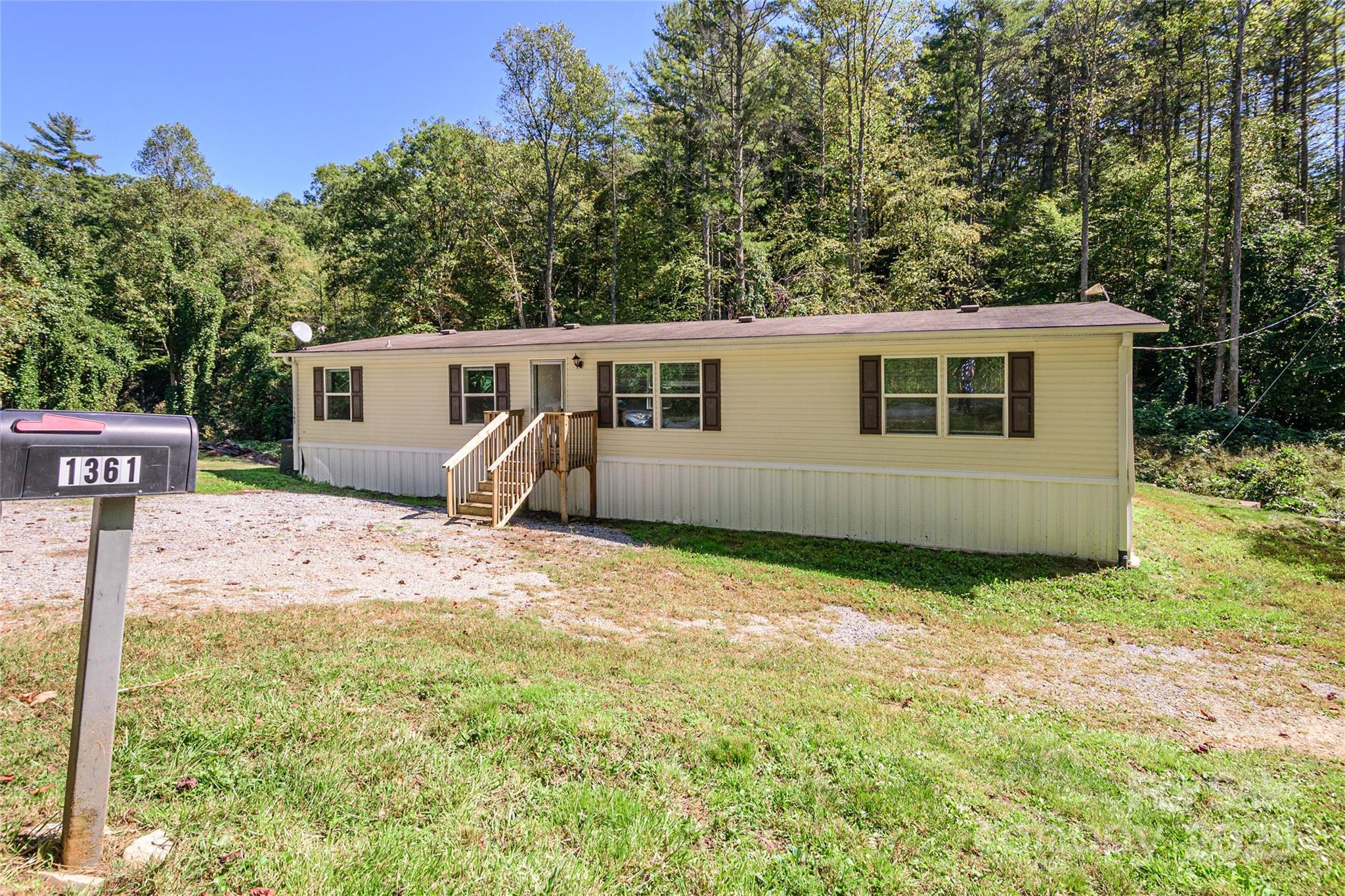 1361 Pleasant Grove Church Road Hendersonville, NC 28739 - Photo 1 of 48 a view of a house with backyard and trees
