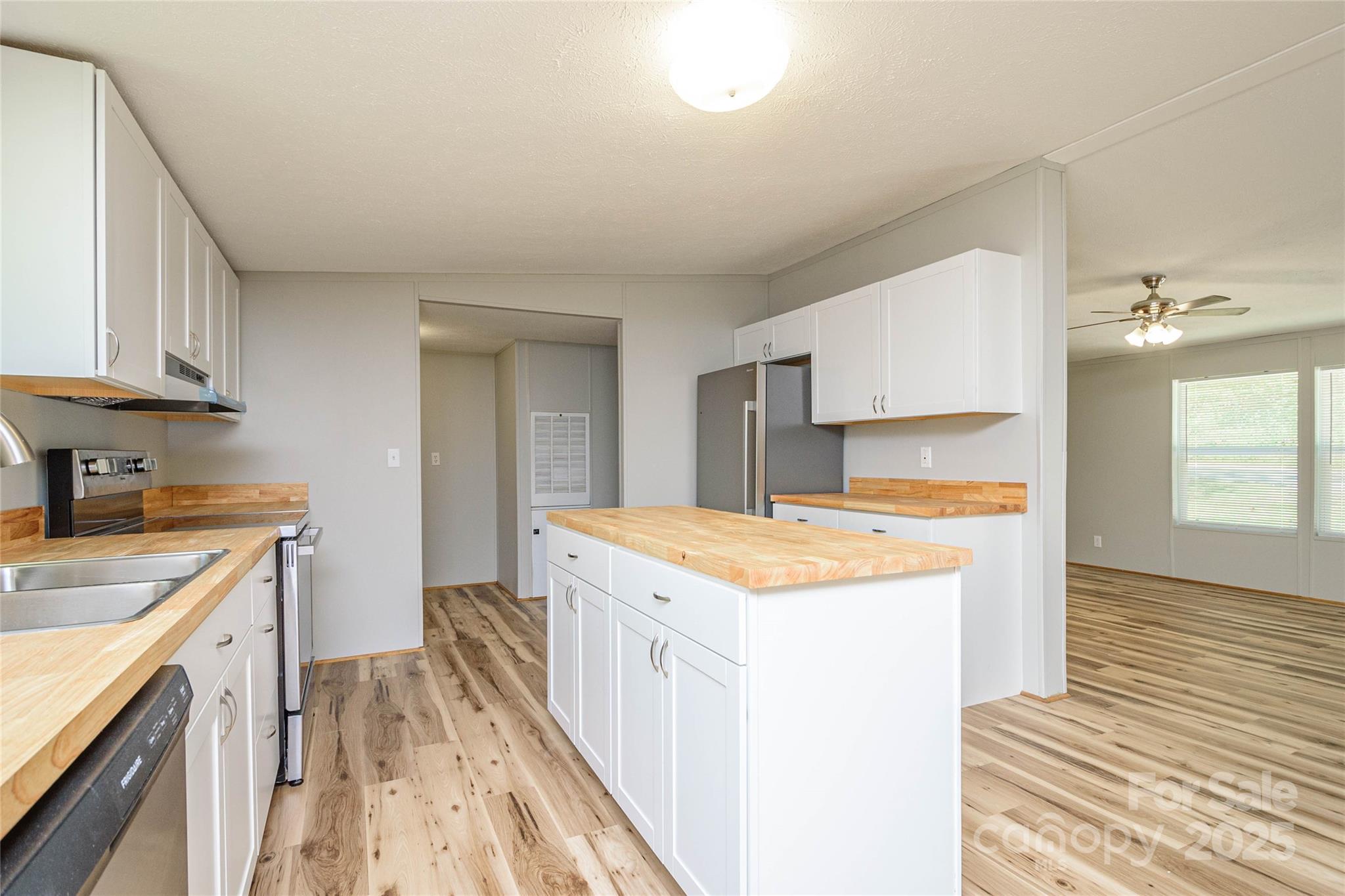 1361 Pleasant Grove Church Road Hendersonville, NC 28739 - Photo 14 of 48 a kitchen with a stove a sink a refrigerator and cabinets