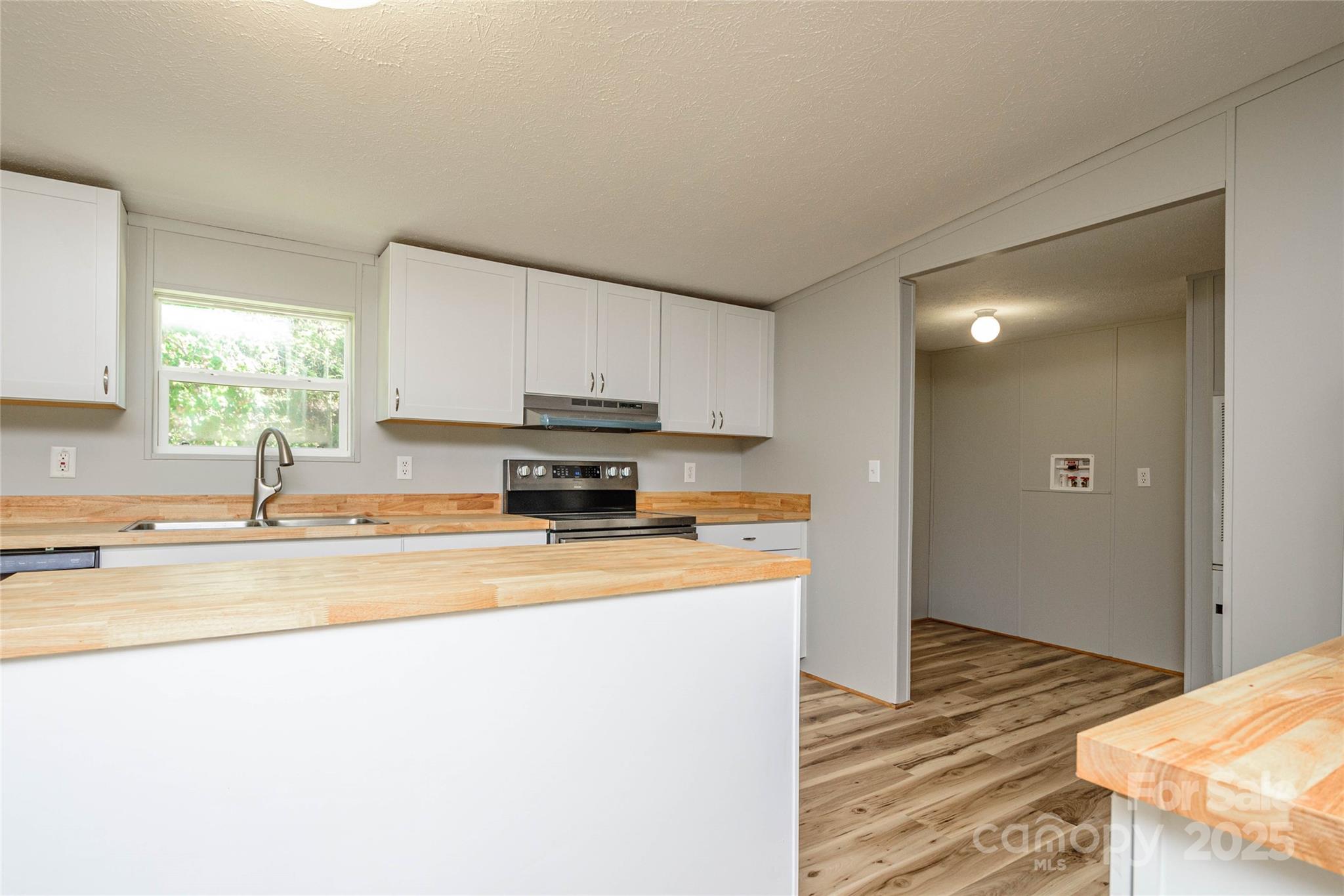 1361 Pleasant Grove Church Road Hendersonville, NC 28739 - Photo 15 of 48 a kitchen with stainless steel appliances granite countertop a sink a stove a refrigerator a window