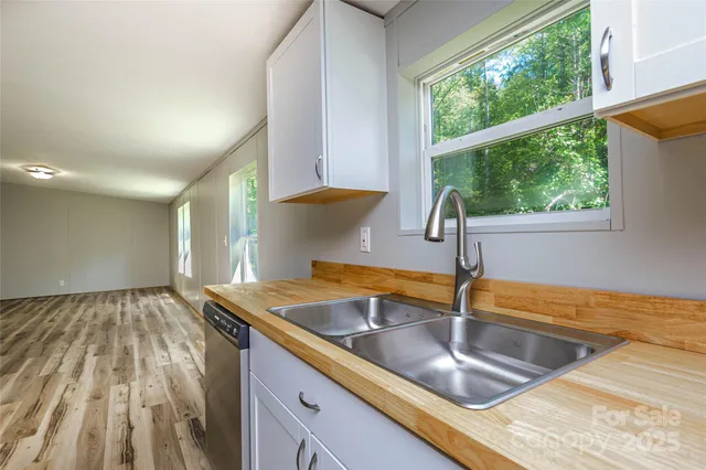 a kitchen with a sink and a large window