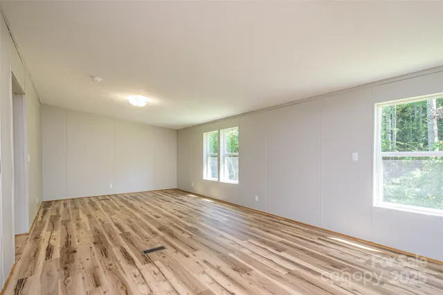 a view of wooden floor and windows in a room