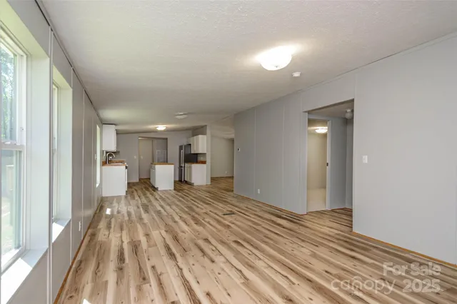 a bedroom with a bed and a view of kitchen