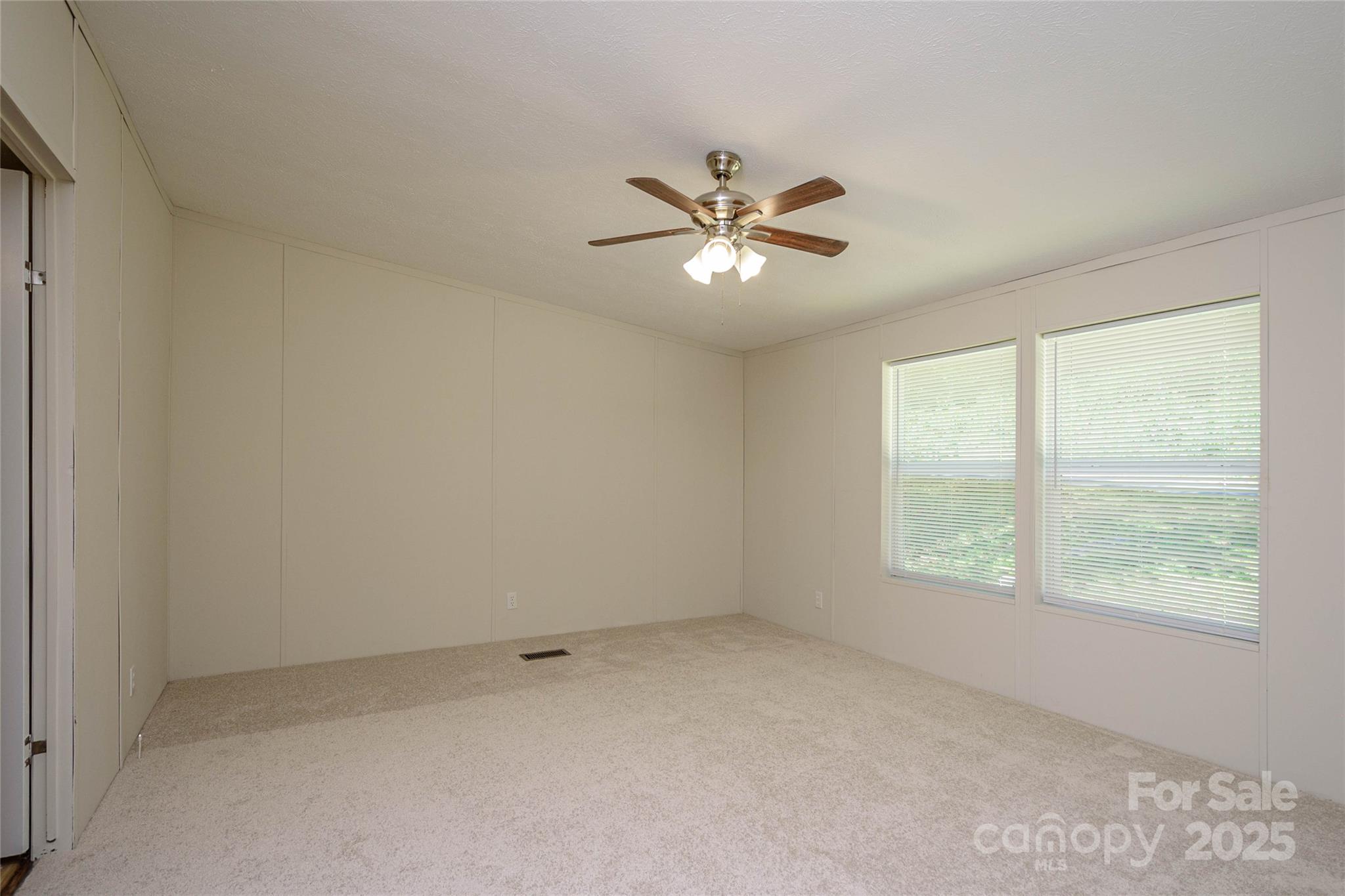 1361 Pleasant Grove Church Road Hendersonville, NC 28739 - Photo 26 of 48 an empty room with a window and a fan