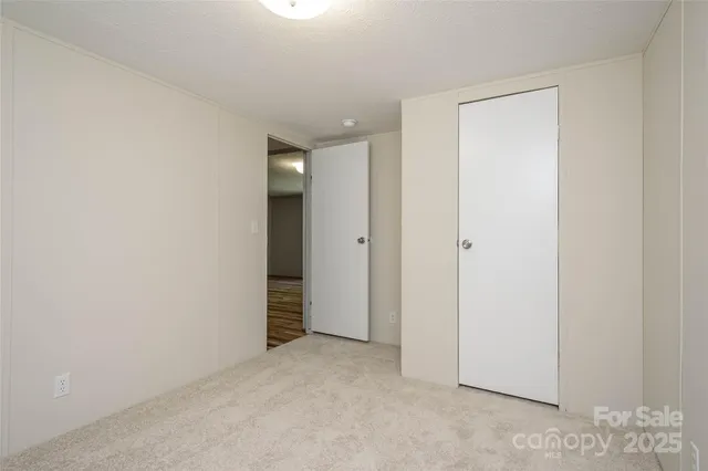 an empty room with closet area
