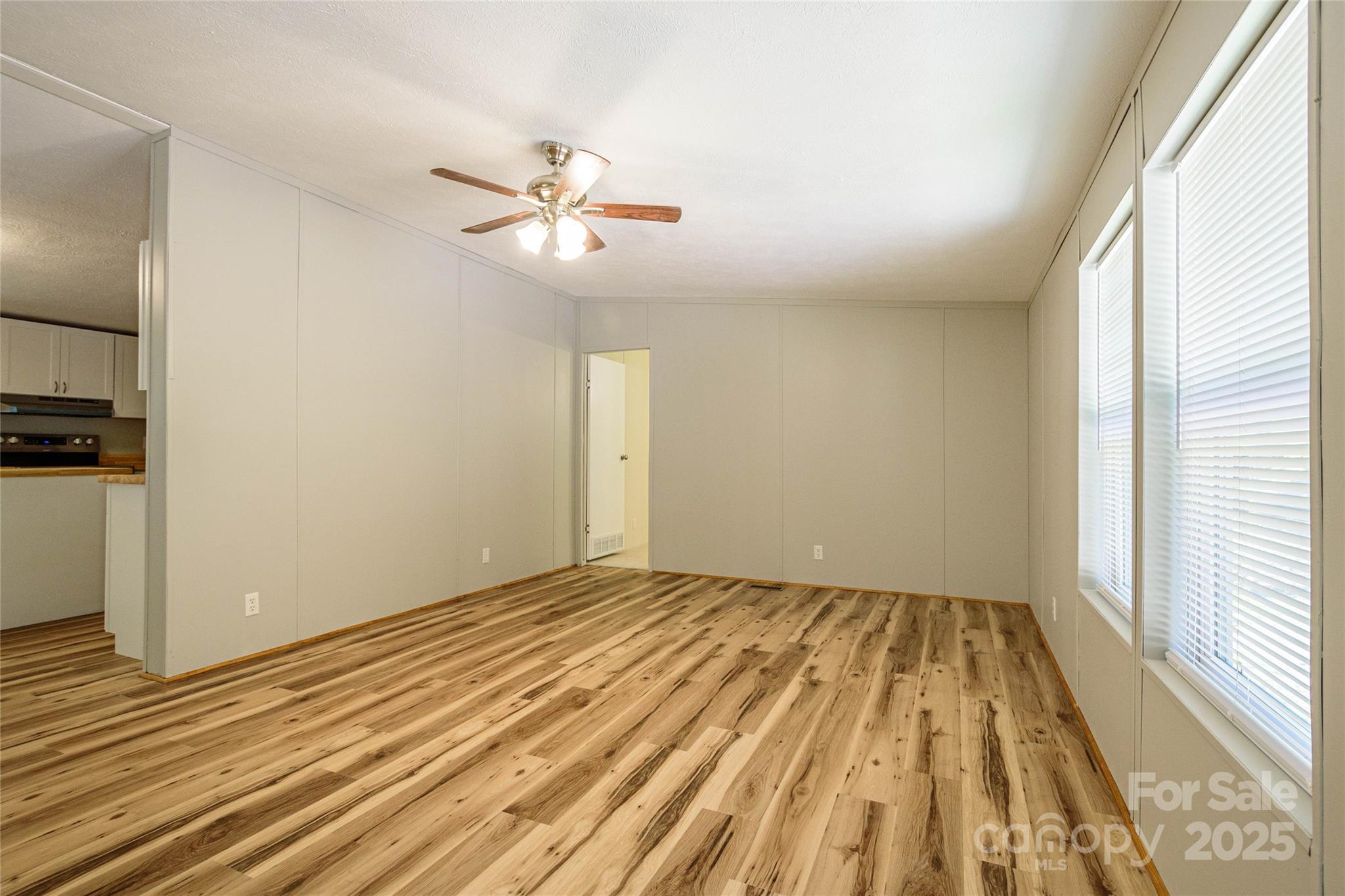 1361 Pleasant Grove Church Road Hendersonville, NC 28739 - Photo 9 of 48 a view of empty room with wooden floor and fan