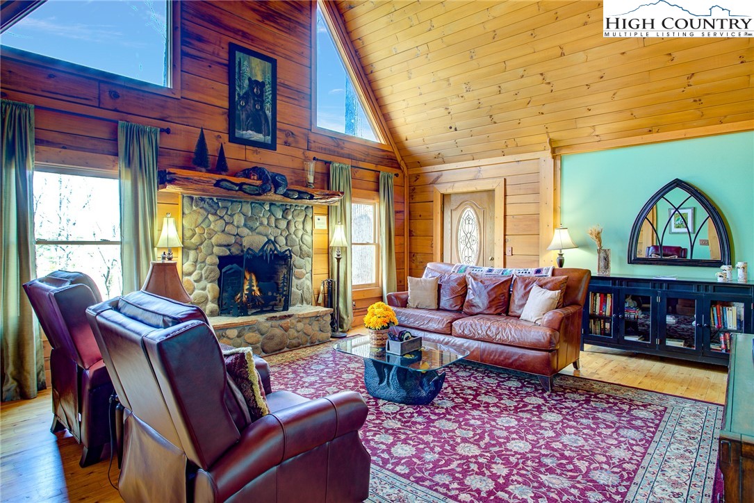 186 Riversound Drive Banner Elk, NC 28604 - Photo 14 of 45 a living room with furniture a fireplace and a table